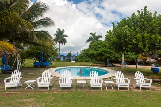 Swimming pool, palm trees and blue sky 