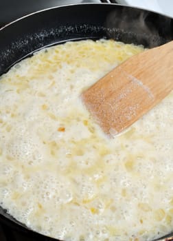  Boiling cream added to the pan to cook the sauce