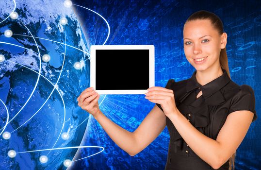 Smiling young woman holging blank tablet with black screen and looking at camera on earth model background. Connection all over the world. Elements of this image furnished by NASA