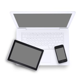 Tablet and mobile phone on laptop in isolated white background, top view