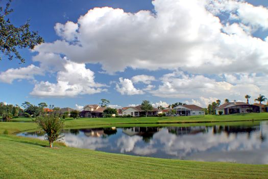 A lake in a residential area with reflections