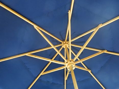 The inside on an open blue umbrella