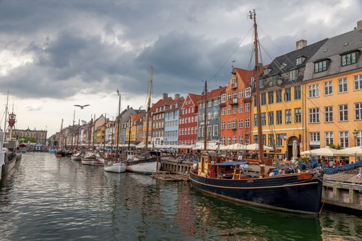 The boats and ships in the calm hurbour of Nyhavn, Copenhagen, Denmark. Nyhavn is waterfront, canal and entertainment district in Copenhagen.