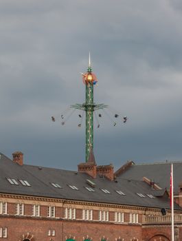 fairground fun fair in tivoli gardens in Copenhagen, Denmark, on a gray sky