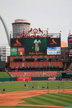 Busch Stadium scoreboard, at the downtown ballpark of the St. Louis Cardinals, with the city skyline and Gateway Arch.