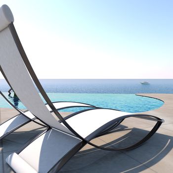 Sun loungers inviting to relaxation and rest near to an infinity pool with panoramic sea views to enjoy life.