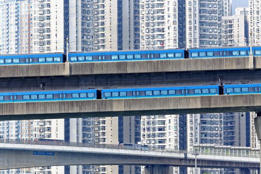 high speed train on bridge in hong kong downtown city at day
