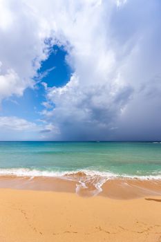 Beach on the tropical island. Clear blue water, sand and clouds. Beautiful vacation spot.