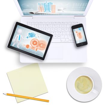 Tablet and mobile phone on laptop with coffee cup on isolated white background, top view