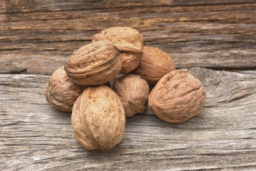 Walnuts on old wooden background