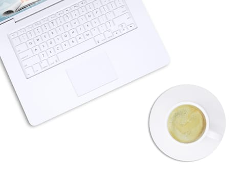 White laptop and coffee cup on isolated white background, top view. Closed up