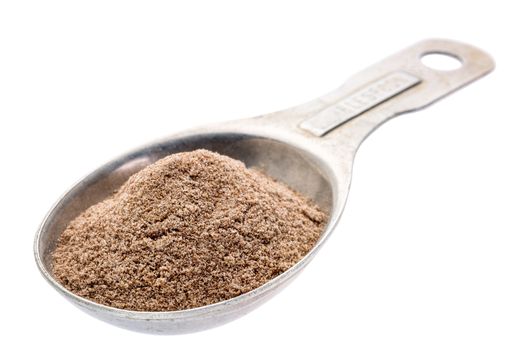 gluten free teff flour on an old aluminum measuring spoon isolated with a clipping path