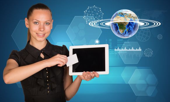 Smiling young woman holging tablet and blank card with 3d Earth model with graphical charts and looking at camera on abstract blue background. Elements of this image furnished by NASA