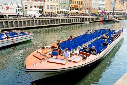 COPENHAGEN, DENMARK - MAY 18: unidentified people in open cafes of the famous Nyhavn promenade on May 18, 2013 in Copenhagen, Denmark. Nyhavn is one of the most famous landmark of Copenhagen.