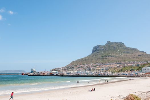 CAPE TOWN, SOUTH AFRICA - DECEMBER 12, 2014:  Hout Bay harbor, a beach and part of the town