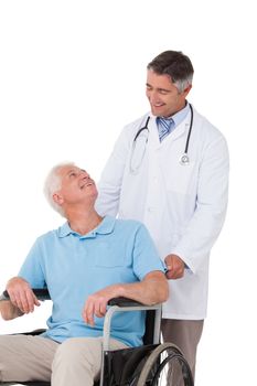 Doctor pushing senior patient in wheelchair on white background