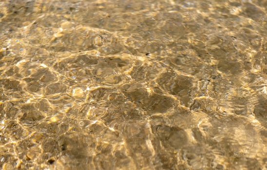 Texture background of water wave on sand at tha beach