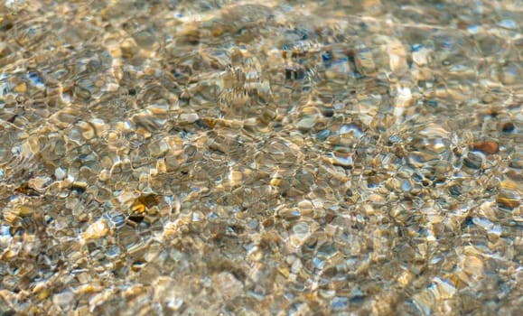 Texture background of water wave on sand at tha beach