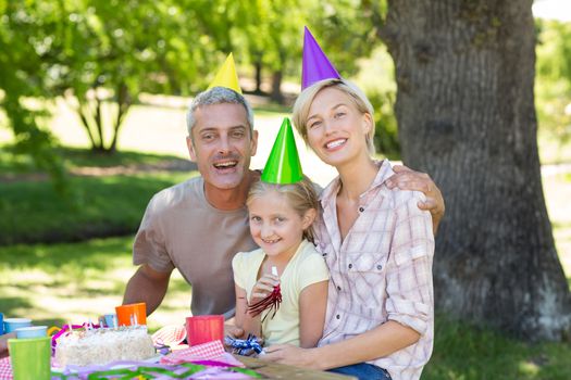 Happy couple with their daughter on a sunny day