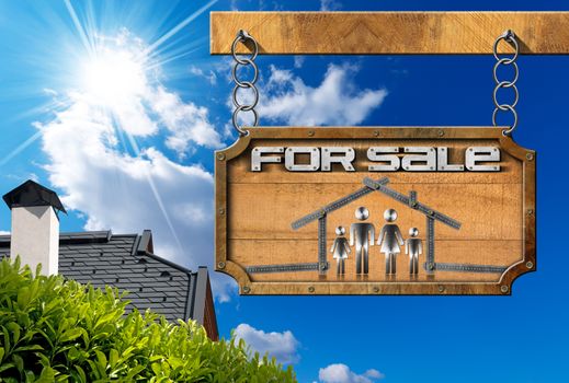 Wooden sign with metallic meter ruler in the shape of house with symbol of a family and text for sale. Real estate sign hanging from a chain on blue sky with roof, clouds and sun rays