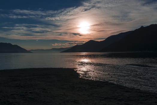 Silhouette and pink sunset over the Lake Maggiore, Maccagno - Italy