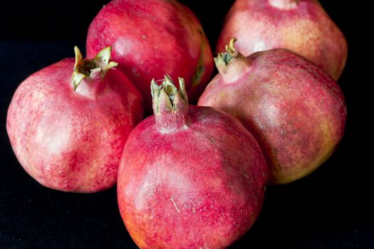 Photo of some pomegranates on black background