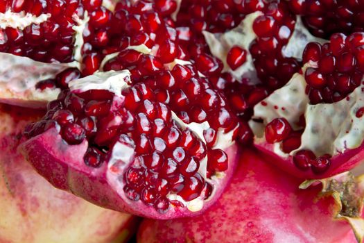 Photo of the dark red pomegranate is cut open