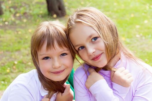 Photo of two playing girls in summer