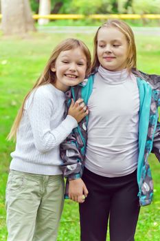 Photo of two playing girls in summer