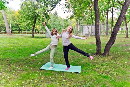 Photo of two playing girls in summer