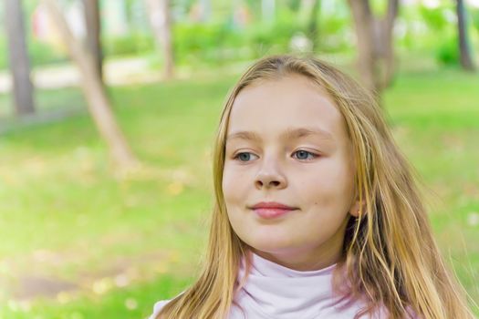 Cute girl with blond long hair and blue eyes
