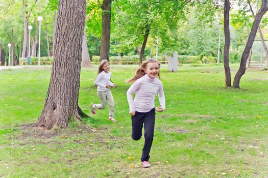 Photo of two running girls in summer