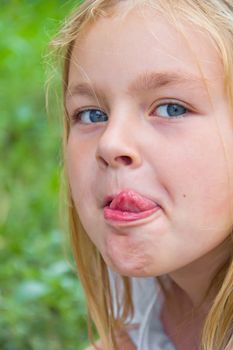 Portrait of cute girl with put out tongue