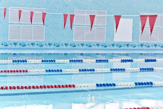Photo of empty swimming pool with red flags