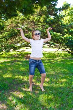 Photo of cute dancing girl with sunglass in summer