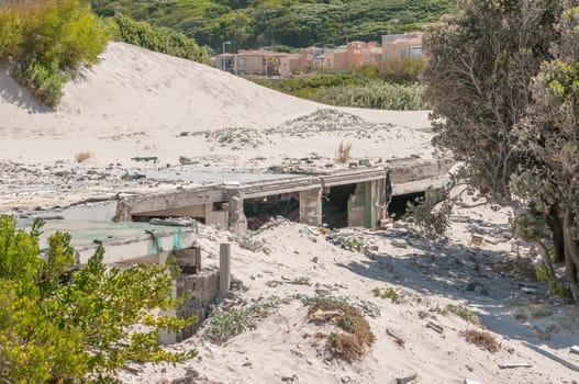 Old police station at Hout Bay reclaimed by sand dunes, Cape Town, South Africa.