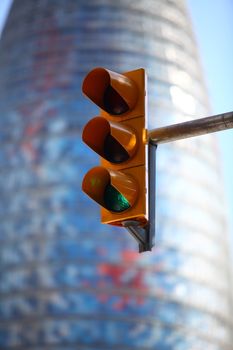 green  traffic light on the background of the cityscape