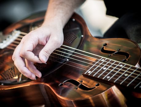 Hands playing guitar in a diagonal position