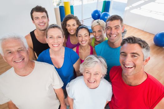 Portrait of happy people standing together at gym