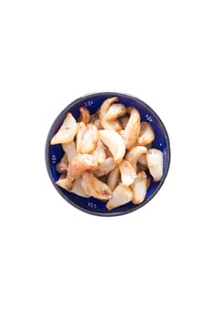 Healthy marinated oven roasted garlic cloves for a savory snack or salad ingredient in a small round dish isolated on white, a popular aromatic ingredient for its pungent taste and medicinal qualities