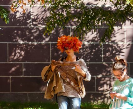 PRINCETON, NJ - OCTOBER 20: Colorful autumn in one of the best and oldest universities in USA, belonging to elite Ivy Leaque, classified at the 1-st place in ranking. Girl with hat made of colorful leaves, October 20, 2013 in Princeton, NJ