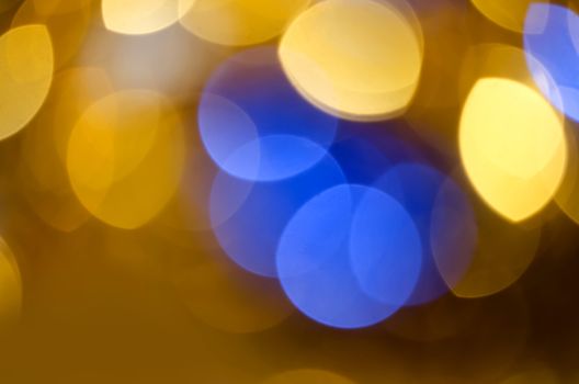 Gold blue blur circle lights as christmas colorful background.