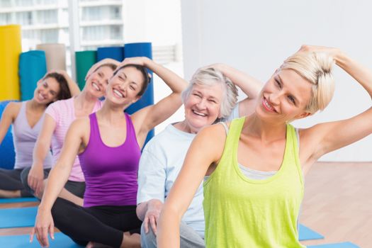 Happy women doing neck exercise at fitness club