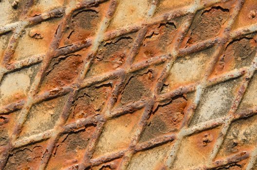 Rusty surface of iron floor, diagonal pattern.