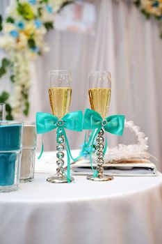 Two elegant champagne glasses on table in restaurant.