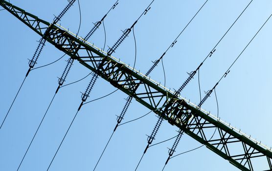 High voltage tower and cabels againts blue sky. 