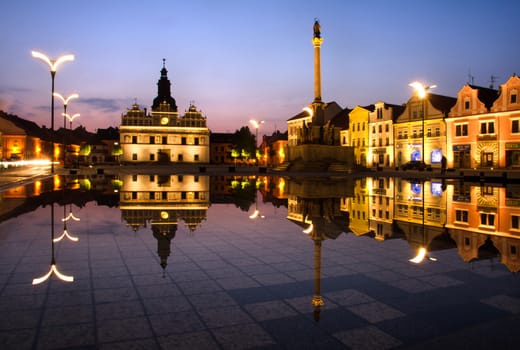 Town square at night and reflection in the water.