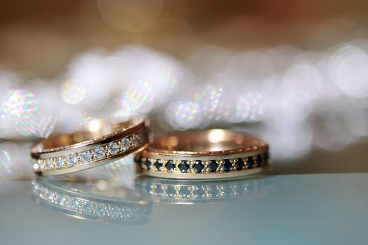 Gold wedding rings laying on the table.