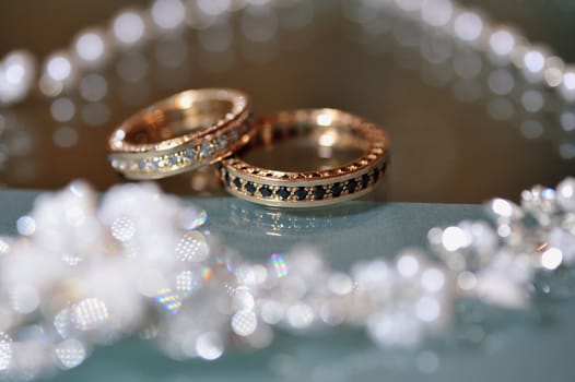 Gold wedding rings laying on the table.