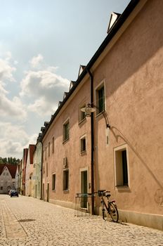 Small street with a bike in the front. 